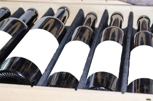 Red and white wine in bottles with white label in a wooden box. 