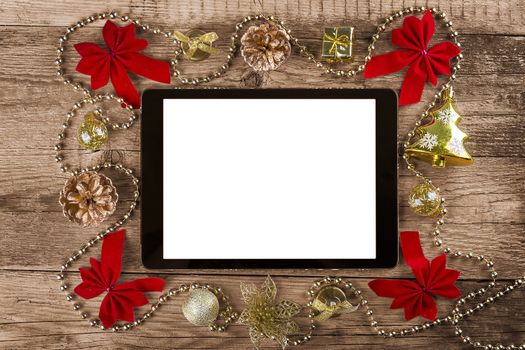 tablet pc with  christmas decorations on wooden background