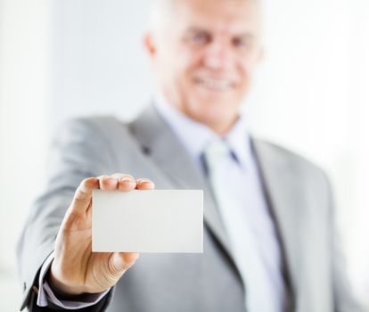 Happy senior businessman holding Blank business card. Selective Focus. Focus on business card.