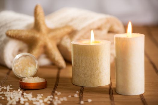 Tranquil scene with Towel, bath salt, Candle, and sea-star.