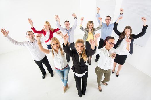 Group of a happy Business People standing together with raised arms.