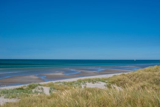 Beach with low tide water in the summer