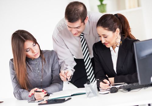 Happy Businessman showing her business team project  in the office.