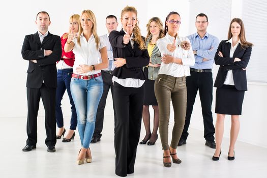 Group of a Successful Business People Showing Thumbs Up and looking at the camera.