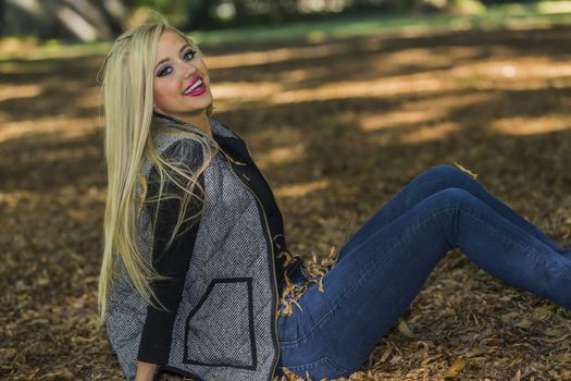 A blonde model posing in an outdoor environment