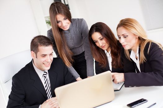 Happy young Business woman showing her colleagues project at laptop in the office.