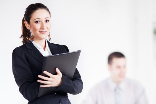 Happy Businesswoman with documents in the office, Looking at camera. Selective Focus.