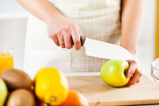 Cutting apple in the kitchen.