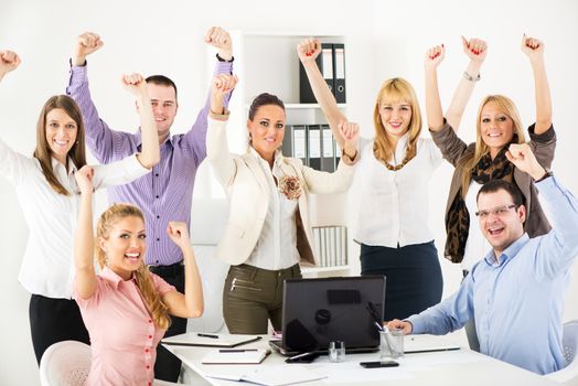 Group of a happy Successful Business People with raised arms looking at camera.