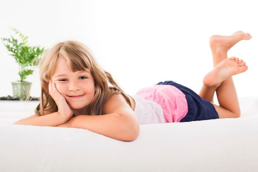 Cute little girl lying on the bed