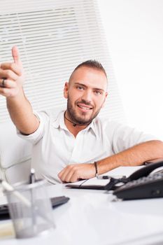 Beautiful young businessman giving thumbs up