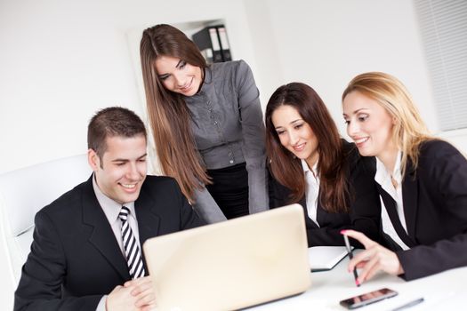 Happy young Business woman showing her colleagues project at laptop in the office.