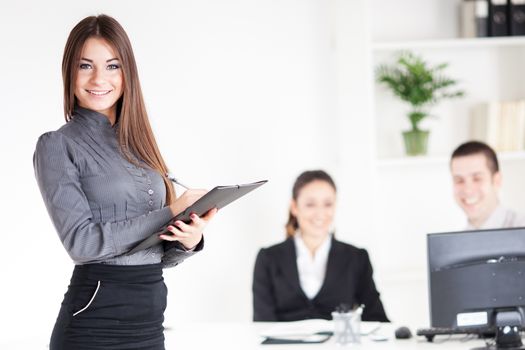 Happy Businesswoman with documents in the office, Looking at camera. Selective Focus.