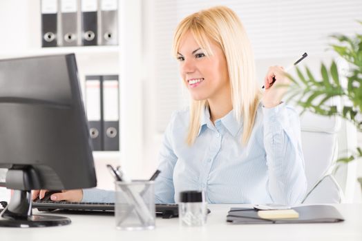 Beautiful Businesswoman working on the computer in the office.