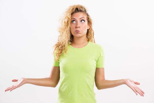 Portrait of beautiful pouty young woman thinking and spreads his arms. White background.