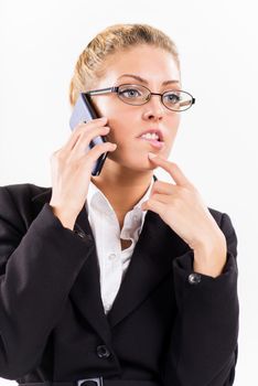 Portrait of attractive businesswoman using a mobile phone. She is thinking.