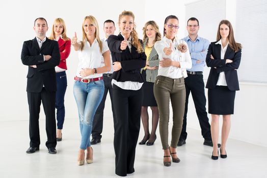 Group of a Successful Business People Showing Thumbs Up and looking at the camera.