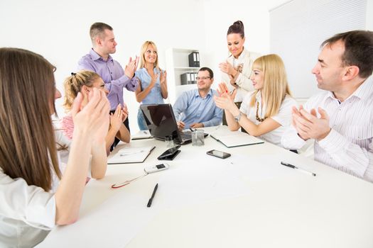 Successful business team congratulates colleague on Successful Presentation with big applauding.