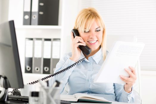 Beautiful Businesswoman telephoning and working in the office.