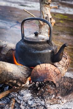 Old kettle  over the fire in camping. 