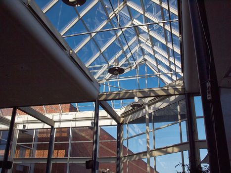 Glass roof of modern building with background of clear blue sky          