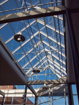Glass roof of modern building with background of clear blue sky