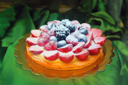 excellent cake covered with strawberries, blueberries, blackberries