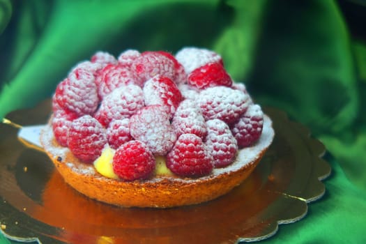 Small pie covered with raspberries