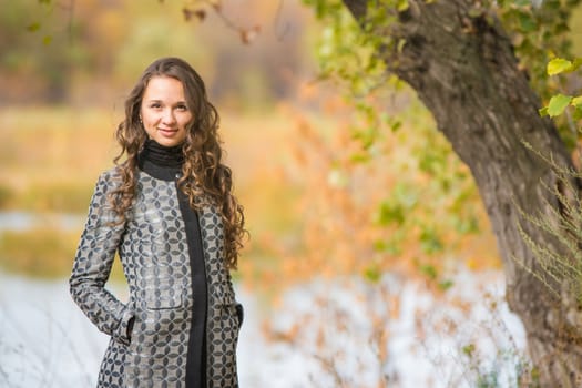 Twenty-five young beautiful girl walks by Europeans autumn forest