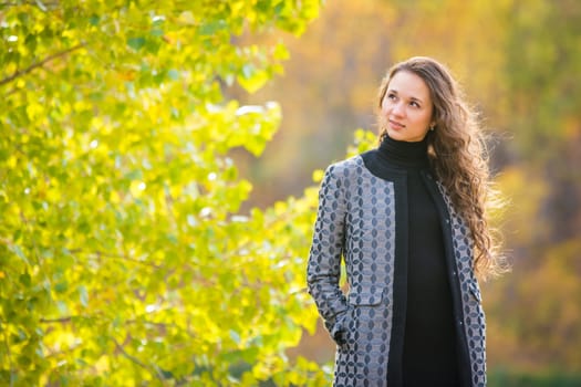 Twenty-five young beautiful girl walks by Europeans autumn forest