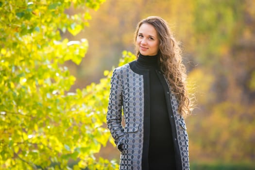 Twenty-five young beautiful girl walks by Europeans autumn forest