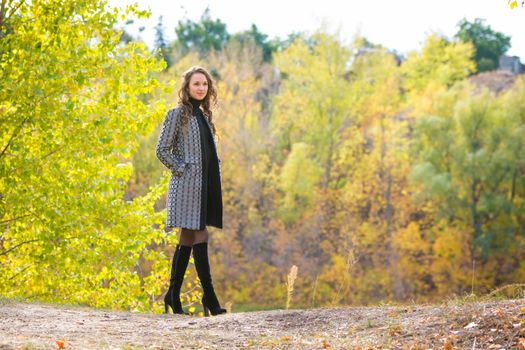 Twenty-five young beautiful girl walks by Europeans autumn forest