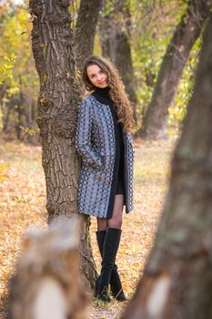 Twenty-five young beautiful girl walks by Europeans autumn forest
