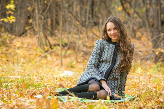 Twenty-five young beautiful girl walks by Europeans autumn forest