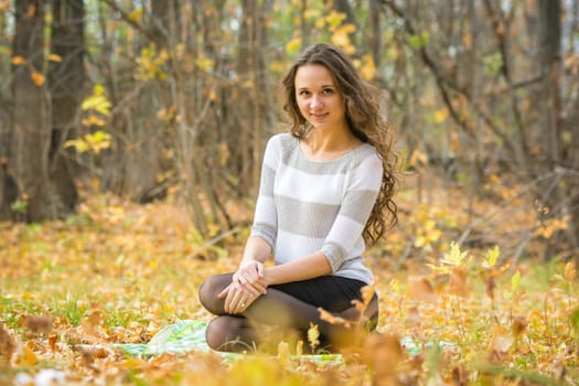 Twenty-five young beautiful girl walks by Europeans autumn forest