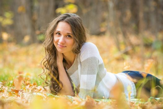 Twenty-five young beautiful girl walks by Europeans autumn forest