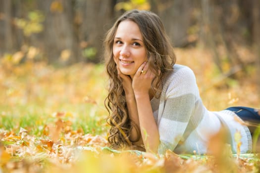 Twenty-five young beautiful girl walks by Europeans autumn forest