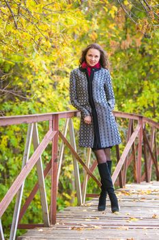 Twenty-five young beautiful girl walks by Europeans autumn forest