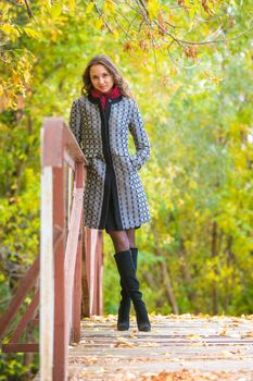 Twenty-five young beautiful girl walks by Europeans autumn forest