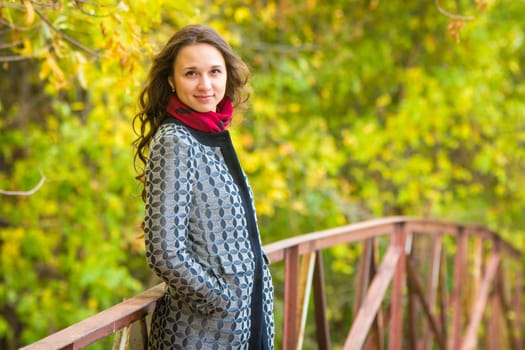 Twenty-five young beautiful girl walks by Europeans autumn forest