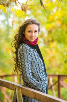 Twenty-five young beautiful girl walks by Europeans autumn forest