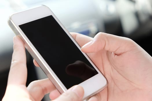 Woman Sitting in the Car and Using Smart Phone