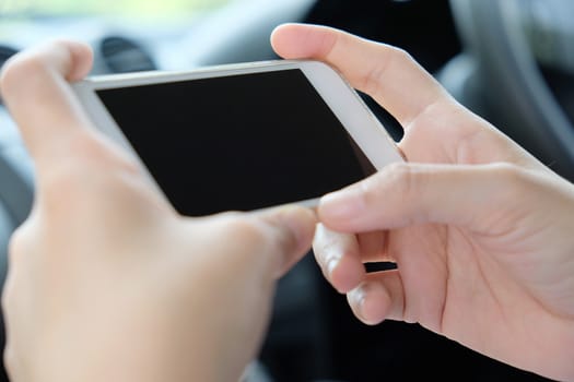 close up image of woman Sitting in the Car and Using Smart Phone