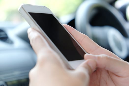close up image of woman Sitting in the Car and Using Smart Phone