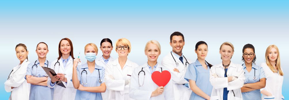 healthcare and medicine concept - smiling doctors and nurses with red heart