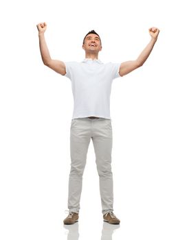 happiness, gesture and people concept - happy man with raised hands