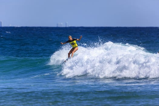 SNAPPER ROCKS, GOLD COAST, AUSTRALIA - 9 MARCH: Unidentified Surfer races the Quiksilver & Roxy Pro World Title Event. 9 March 2013, Snapper Rocks, Gold Coast, Australia