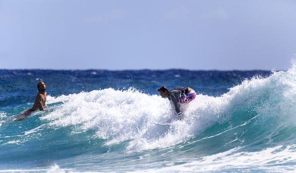 SNAPPER ROCKS, GOLD COAST, AUSTRALIA - 9 MARCH: Unidentified Surfer races the Quiksilver & Roxy Pro World Title Event. 9 March 2013, Snapper Rocks, Gold Coast, Australia