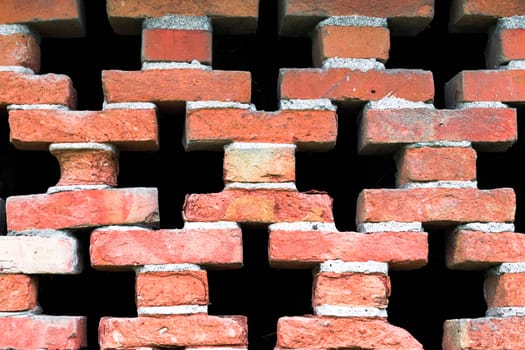 Detail of the window of an old barn built with bricks.