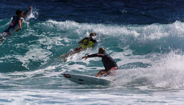 SNAPPER ROCKS, GOLD COAST, AUSTRALIA - 9 MARCH: Unidentified Surfer races the Quiksilver & Roxy Pro World Title Event. 9 March 2013, Snapper Rocks, Gold Coast, Australia